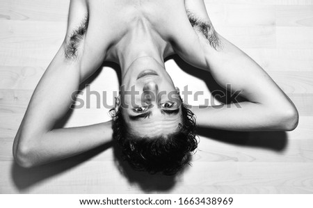 black and white portrait photography. expressive mediterranean Italian dark haired handsome male model boy with angel face and fit sportive body posing for casual fashion shooting