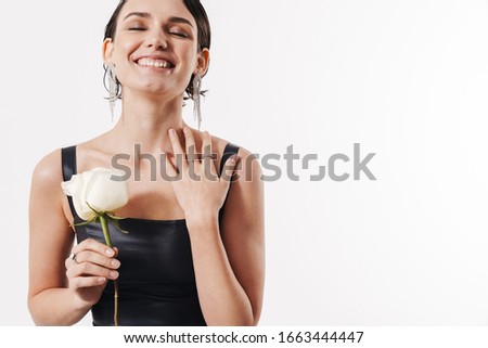 Image of charming young glamorous pretty woman smiling and holding white flower isolated over white background