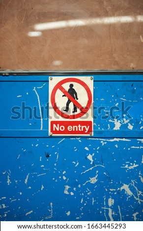 A no entry restricted access health and safety sign to deny personal with no access clearance. Off limits in an industrial factory setting. danger ahead, health and safety hazard warning.