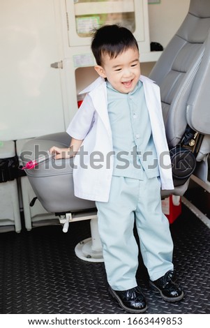 Asian little boy in a doctor suit in Ambulance