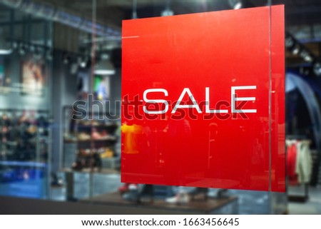 Picture of shop window display with text Sale on red poster. Shopping Sale background.