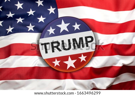 Donald Trump campaign button on the United States of America flag. Royalty-Free Stock Photo #1663496299