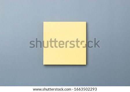 yellow sticky note with dramatic shade on grey background to add text copy space