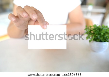 Woman showing blank business name card
