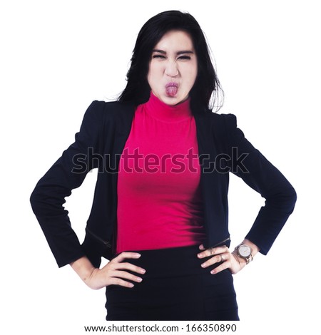 Portrait of businesswoman sticking out tongue isolated over white background