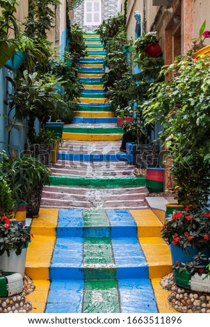 Colorful stairs among historical buildings in the old medina (Jewish neighborhood in the downtown) in Fez (capital of the Fas-Meknas region), in Morocco, Africa.  Royalty-Free Stock Photo #1663511896