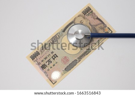 Stethoscope and banknotes with medical insurance concept.