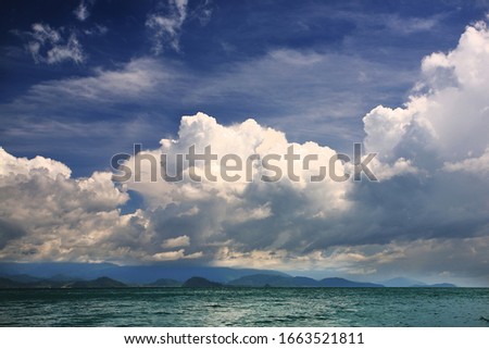A picture of blue sky, white cloud with sea and mountain from south of Thailand.