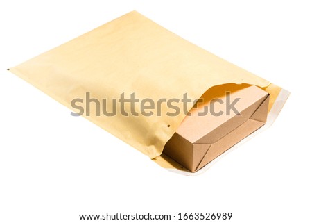 Brown cardboard box inside of large postal envelope