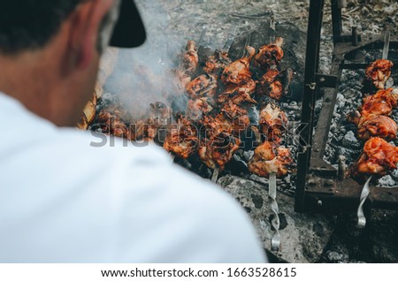 Photographer in the woods taking pictures of barbecue