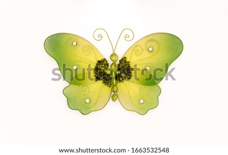 Butterfly in fabric of green color on a white background