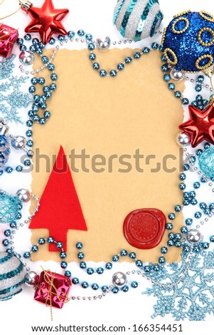 Frame with vintage paper and Christmas decorations close up