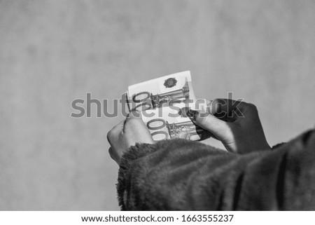 Hand counting holding and showing euro money or giving money. World money concept, 100 EURO banknotes EUR currency isolated with copy space. Concept of rich business people, saving or spending money.