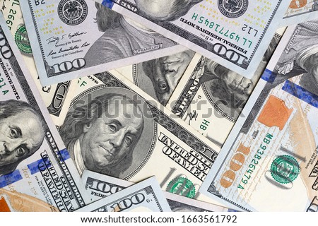 US dollars scattered randomly on the table, close up, background
