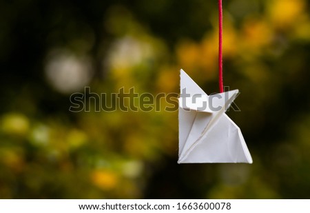 Flying origami in a garden