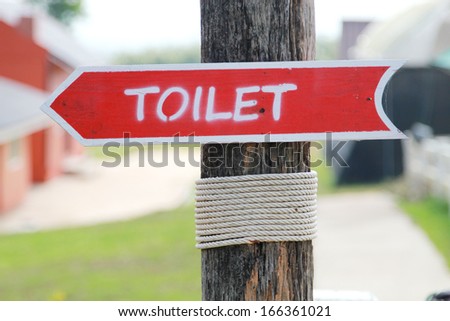 Toilet wood arrow sign