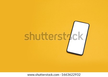 Top view mockup black smartphone on yellow background. Desktop blank smartphone