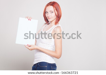 Beautiful woman holding billboard sign. Studio shot