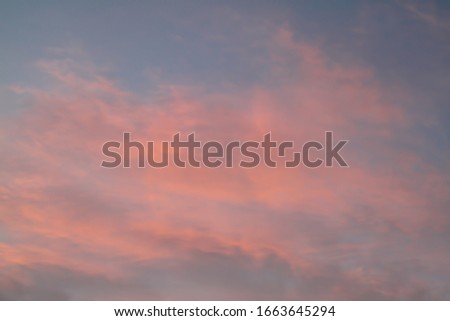  Dramatic red and orange sky and clouds abstract background. Red-orange clouds on sunset sky. Warm weather background. Art picture of sky at dusk