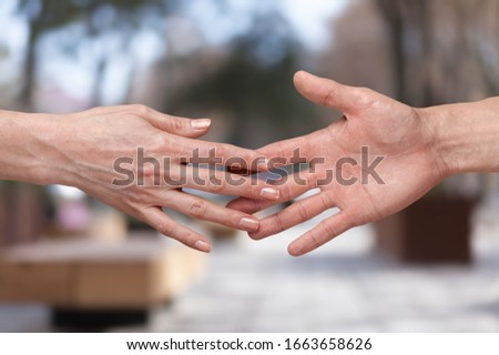 Human hands pulling one to another