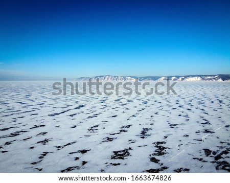 Scenic endless ice view of Baykal Lake near Listvyanka village, Russia