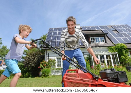 In garden of solar paneled house Royalty-Free Stock Photo #1663685467