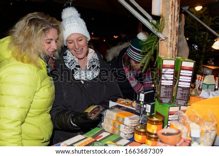 Friends at a food stall, Christmas market, Planegg, Bavaria, Germany, Europe
