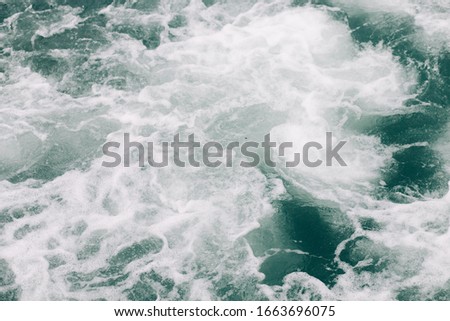 seething sea foam from a wave that broke on a rock. natural sea background