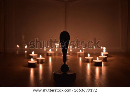 Exclamation mark and candle lights. Dark environment.