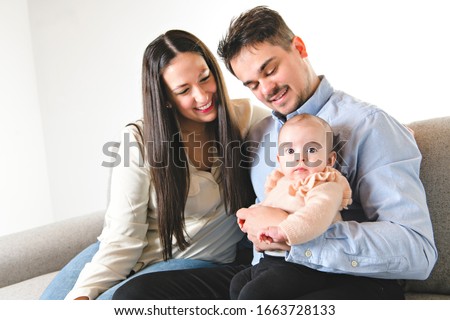nice family with baby girl on the sofa