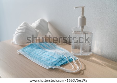 Coronavirus corona virus prevention travel surgical masks and hand sanitizer gel for hand hygiene spread protection. Royalty-Free Stock Photo #1663756195