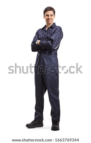 Full length portrait of a young male worker in an overall uniform posing and smiling isolated on white background Royalty-Free Stock Photo #1663769344