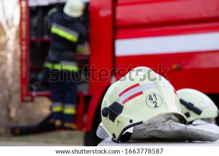 Fireman gear on fire truck. Firefighter helmet