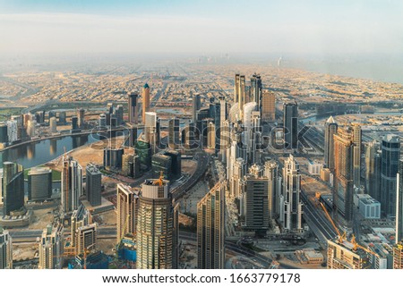 Aerial panoramic view of Dubai downtown skyline with commercial buildings and skyscrapers in morning dust, United Arab Emirates.