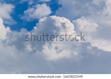 A clear blue sky with white clouds