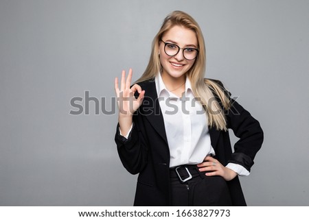 Portrait of happy smiling young cheerful businesswoman, showing