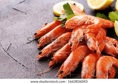 Raw fresh Prawns Langostino Austral. shrimp seafood with lemon and spices on table
