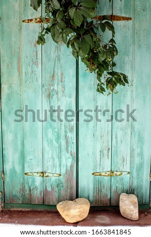 Old turquoise painted wooden window in Greek island Paros