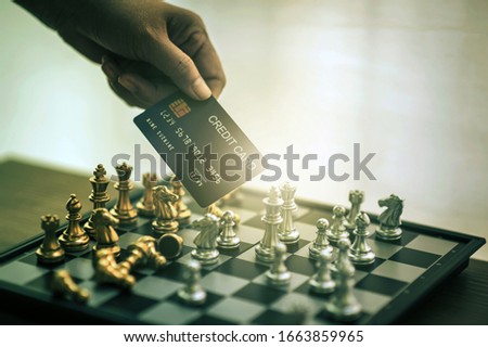 International chess on a chessboard shows its intent on the business competition with credit cards, debit cards that show comfort in the cash era, cash is paid by credit cards, the concept of business