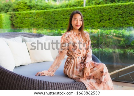 Portrait beautiful young asian women happy smile sit on sofa around outdoor view