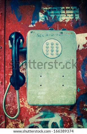 Old payphone in grunge style Royalty-Free Stock Photo #166389374