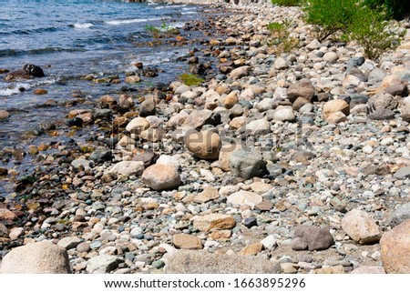 A beach with a lot of stones. Nahuel Huapi Lake. Bariloche, Argentina