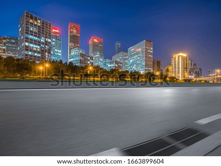Asphalt highway and modern business district office buildings in Beijing at night, China