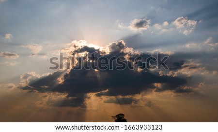 Rain cloud, Black clouds and light beam from the sun
