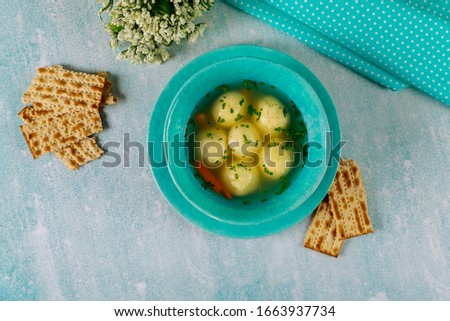 Delicious matzo ball soup with carrot and matzos bread. Jewish holiday concept.