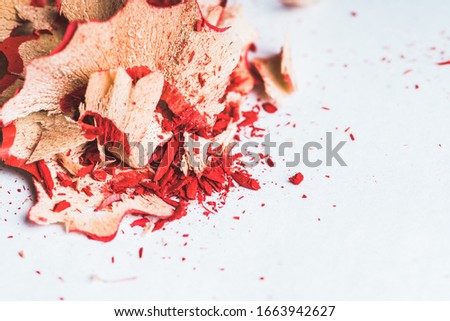 Sharpening shavings on the rustic background. Selective focus. Abstract background.