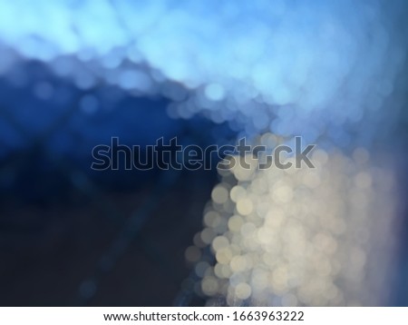 Abstract blurred light blue and black bokeh background