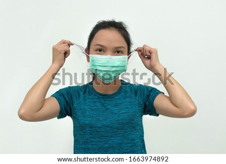 Asian woman wearing facial mask for protection from air pollution or virus epidemic.