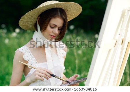 young woman in a straw hat in the fresh air