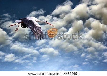 stork in flight bringing baby in basket on cloudy sky background Royalty-Free Stock Photo #166399451